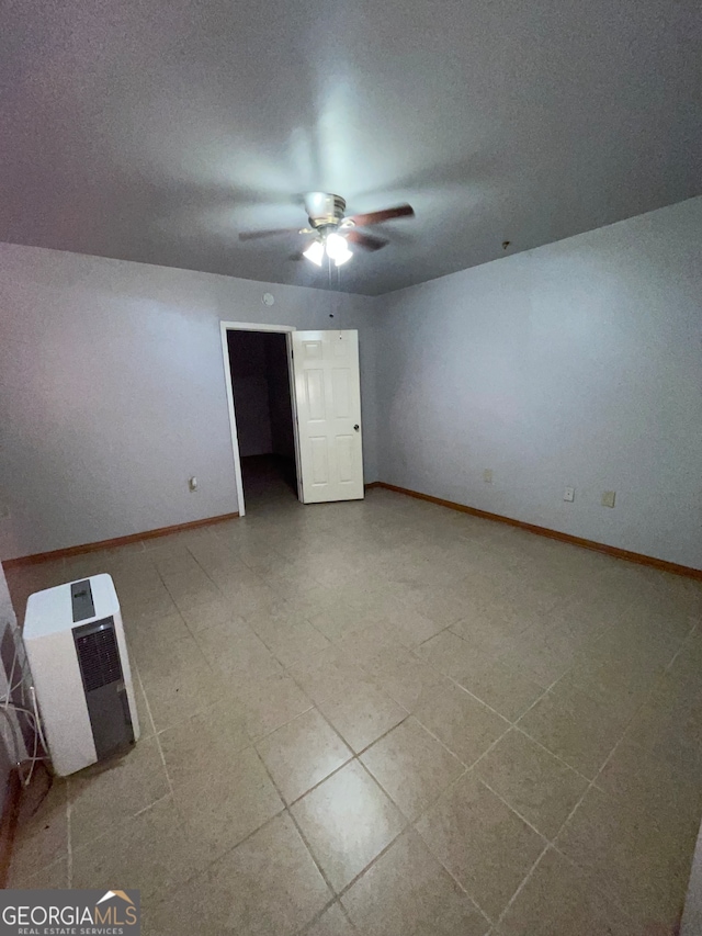 unfurnished bedroom featuring a textured ceiling, tile patterned floors, and ceiling fan