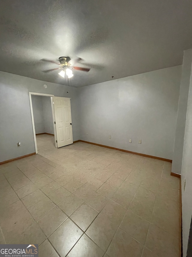 unfurnished bedroom featuring ceiling fan and light tile patterned floors