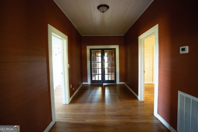 doorway with french doors, hardwood / wood-style flooring, and wood ceiling