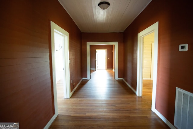 hallway featuring wood ceiling and wood-type flooring