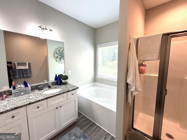 bathroom featuring vanity, hardwood / wood-style flooring, and separate shower and tub