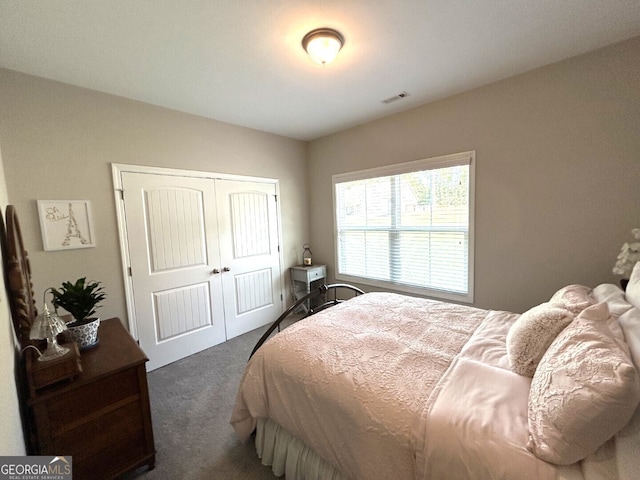 bedroom featuring dark colored carpet and a closet