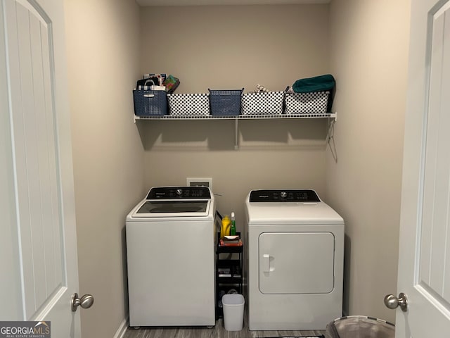 laundry room featuring washer and clothes dryer and hardwood / wood-style flooring