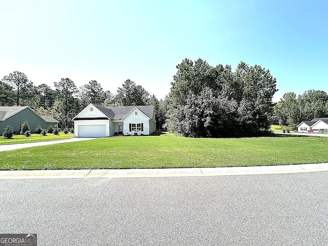 view of front of home featuring a garage and a front lawn