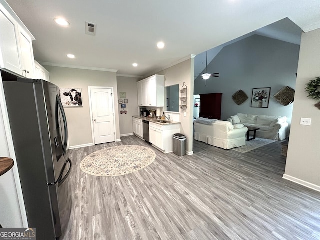 kitchen featuring white cabinets, hardwood / wood-style flooring, dishwasher, and black refrigerator