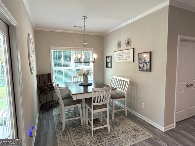 dining area featuring dark hardwood / wood-style floors, a notable chandelier, and ornamental molding