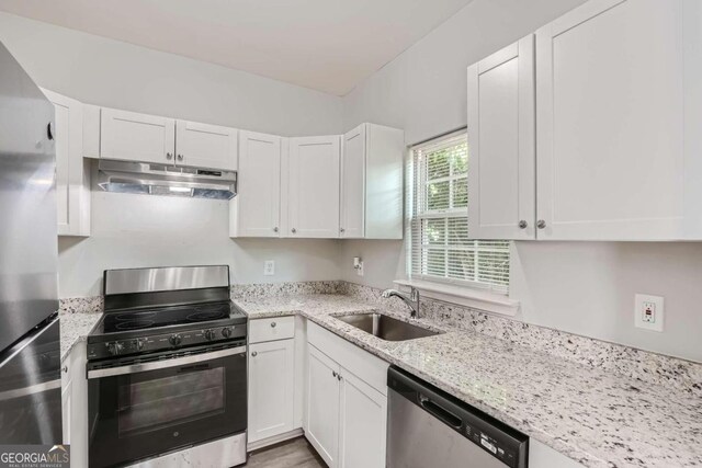 kitchen with sink, appliances with stainless steel finishes, and white cabinets