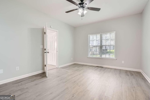 empty room featuring visible vents, baseboards, wood finished floors, and ceiling fan