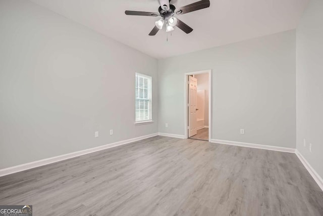 empty room with baseboards, a ceiling fan, and wood finished floors