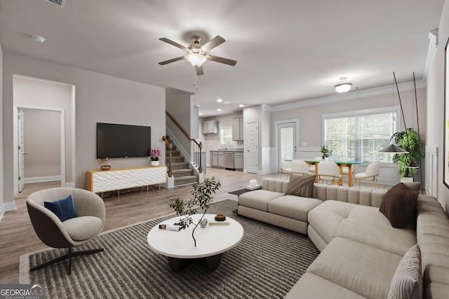 living room with crown molding, ceiling fan, and hardwood / wood-style floors