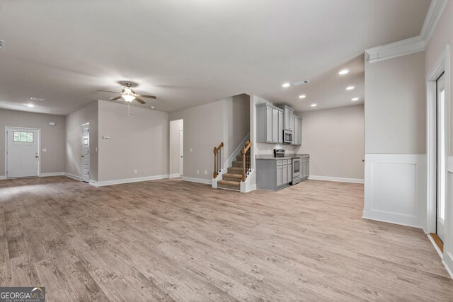 unfurnished living room with ceiling fan and light wood-type flooring