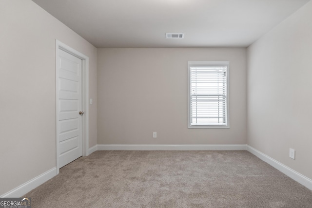 unfurnished room with light colored carpet