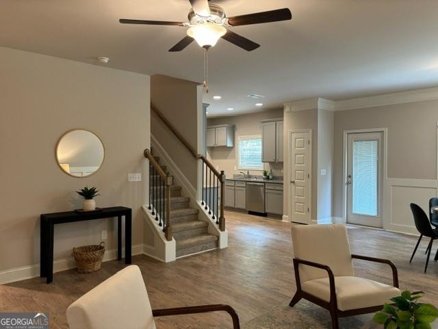 living room featuring hardwood / wood-style floors and ceiling fan