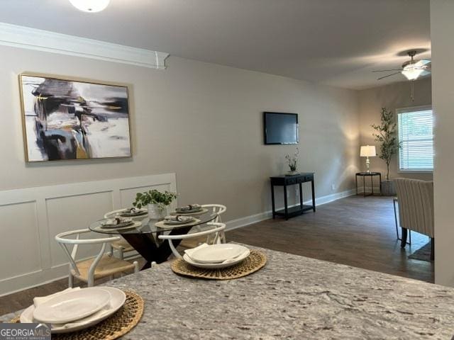 dining room featuring ceiling fan, ornamental molding, and dark hardwood / wood-style flooring