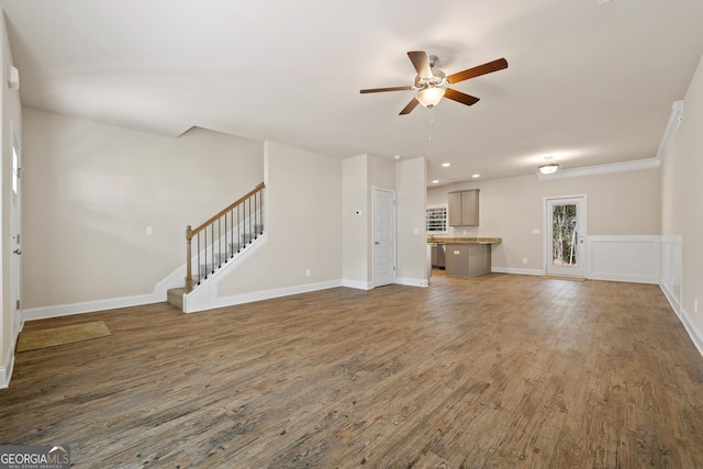 unfurnished living room featuring ceiling fan and dark hardwood / wood-style flooring