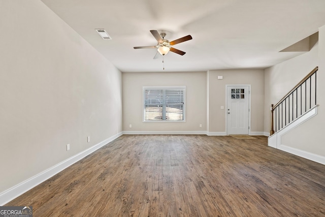 foyer entrance featuring dark wood-type flooring and ceiling fan