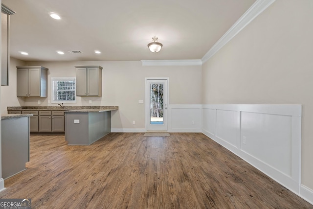 kitchen with crown molding, dark wood-type flooring, sink, and gray cabinetry