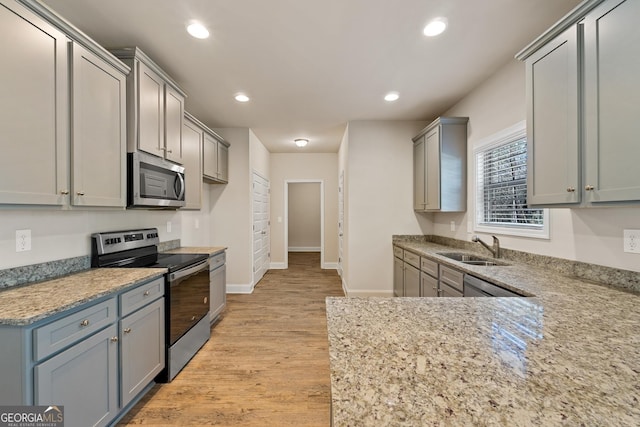 kitchen with stainless steel appliances, gray cabinets, and sink