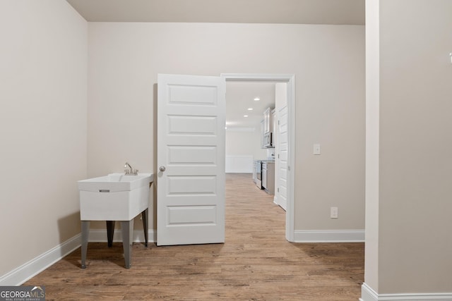 laundry area featuring light wood-type flooring