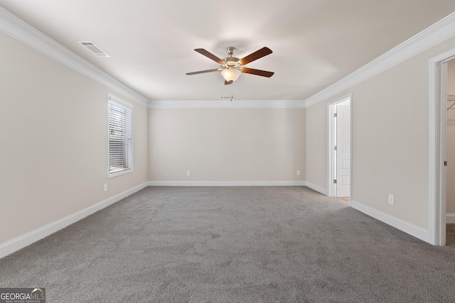 empty room featuring carpet floors, ornamental molding, and ceiling fan