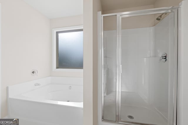 bathroom featuring separate shower and tub