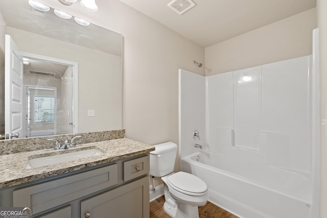 full bathroom with vanity, toilet, shower / bath combination, and hardwood / wood-style floors