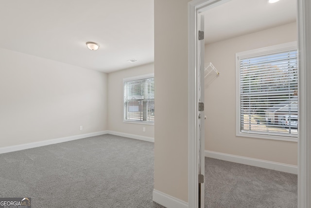 unfurnished room featuring light colored carpet