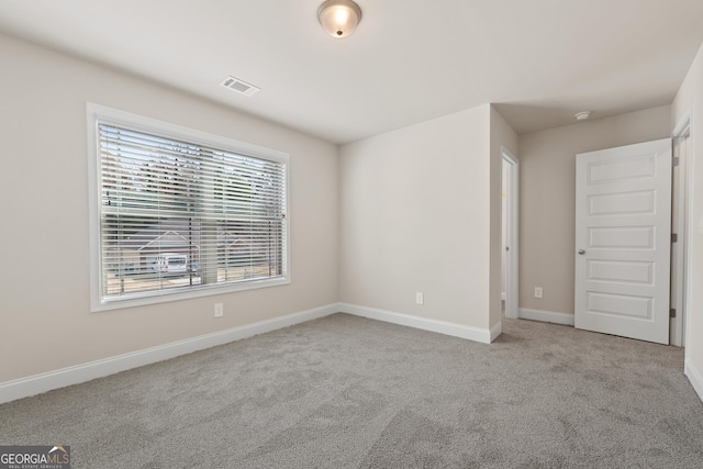 empty room with light colored carpet