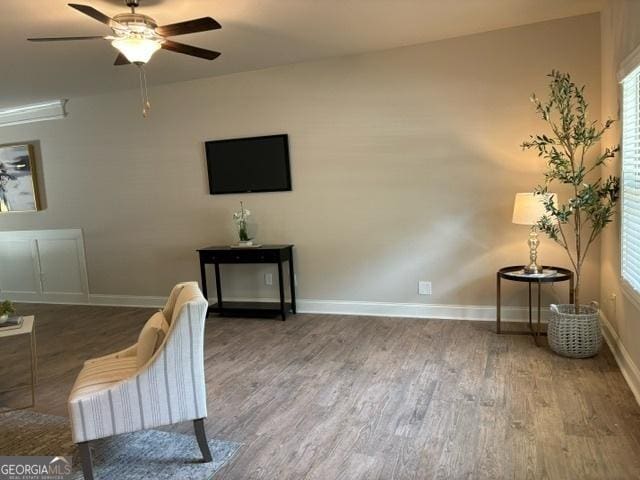 living room with dark hardwood / wood-style floors and ceiling fan