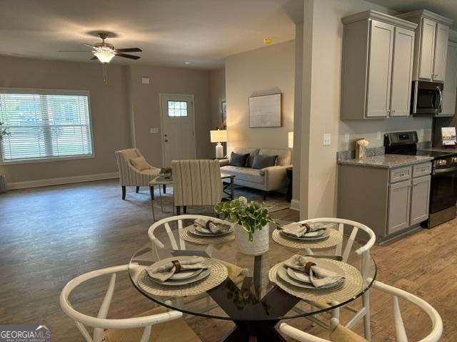 dining space featuring hardwood / wood-style floors and ceiling fan