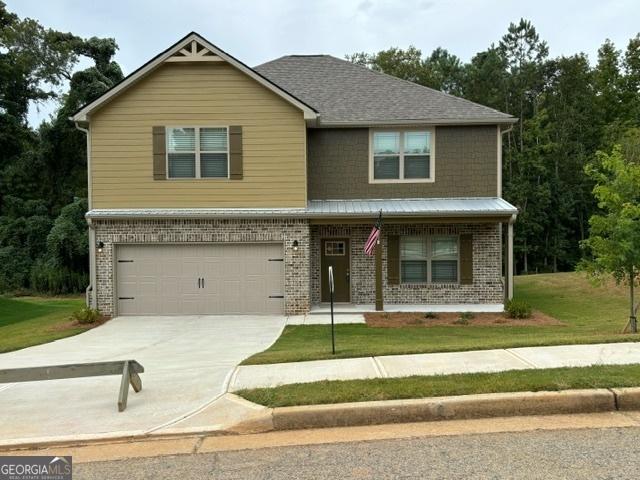 view of front facade with a garage and a front yard