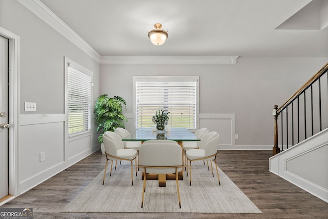 dining area with ornamental molding and dark hardwood / wood-style floors