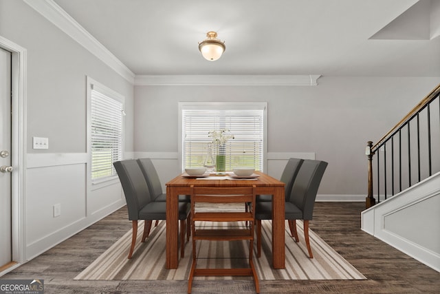 dining area with crown molding and dark hardwood / wood-style flooring