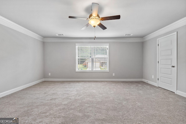 carpeted spare room featuring ornamental molding and ceiling fan