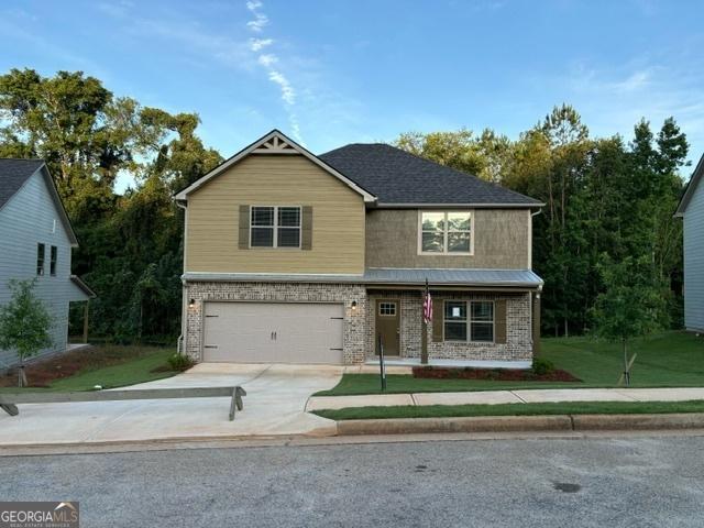 view of front of property with a garage and a front yard