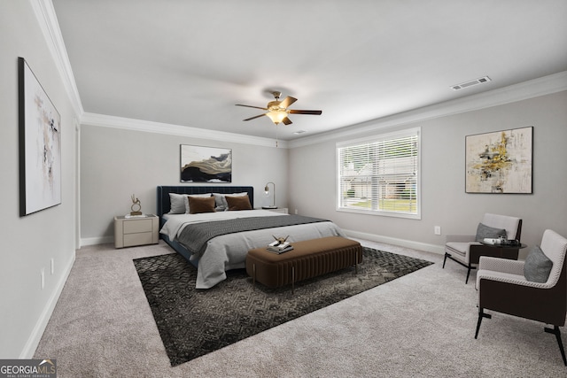 carpeted bedroom with ornamental molding and ceiling fan