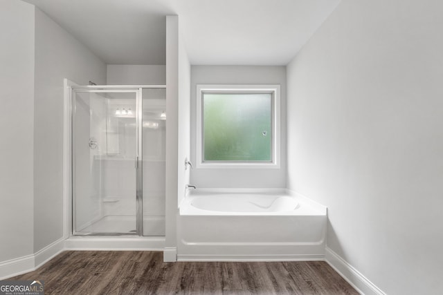 bathroom featuring shower with separate bathtub and hardwood / wood-style floors