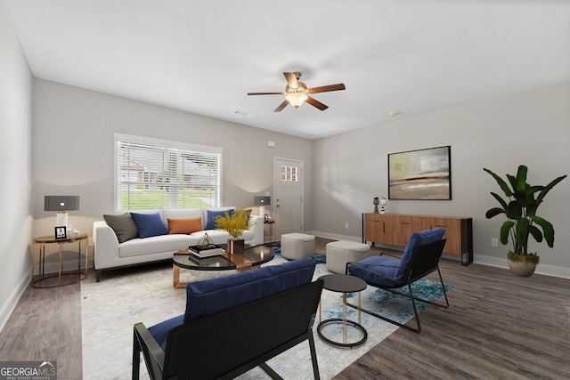 living room with ceiling fan and dark hardwood / wood-style flooring