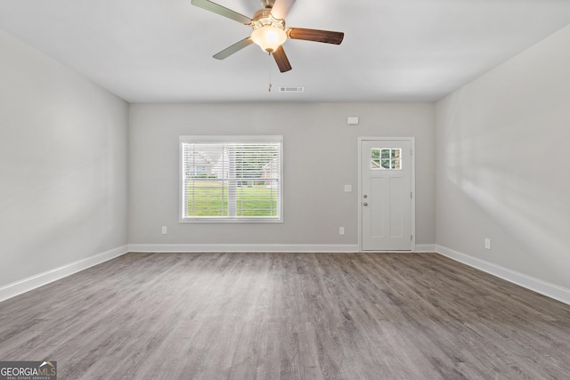 spare room with wood-type flooring and ceiling fan