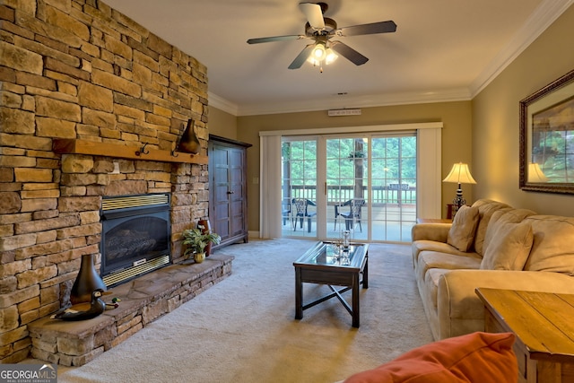 living room with carpet floors, crown molding, a fireplace, and ceiling fan