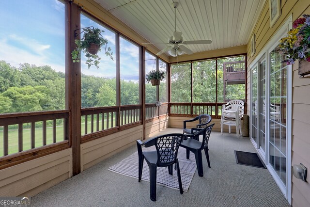 sunroom featuring ceiling fan and a wealth of natural light