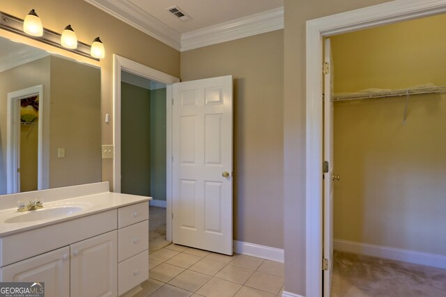 bathroom with ornamental molding, vanity, and tile patterned floors