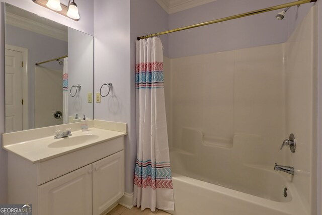 bathroom featuring crown molding, shower / bathtub combination with curtain, and vanity