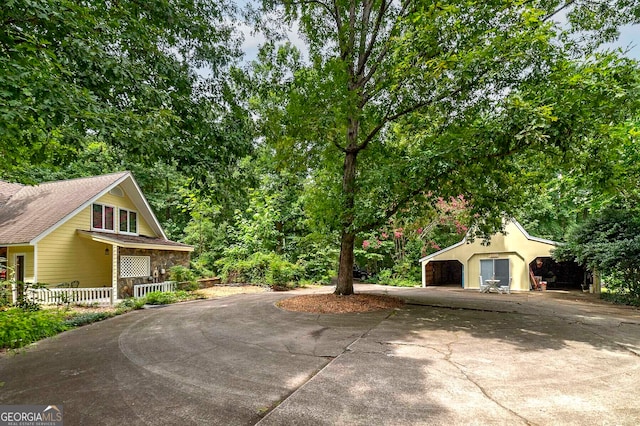 view of side of property with a garage and a porch