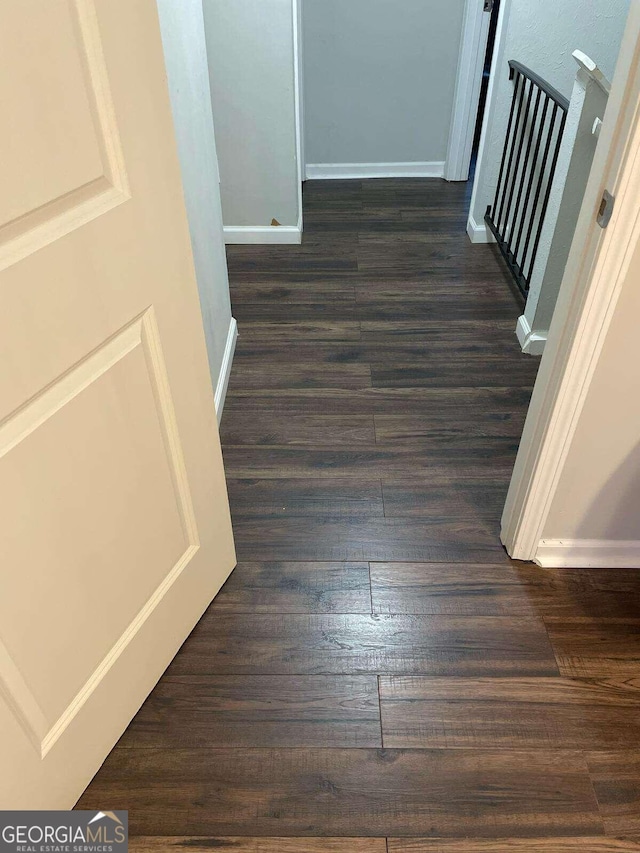 corridor featuring dark hardwood / wood-style floors