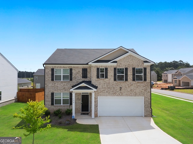 view of front of property with a garage and a front lawn