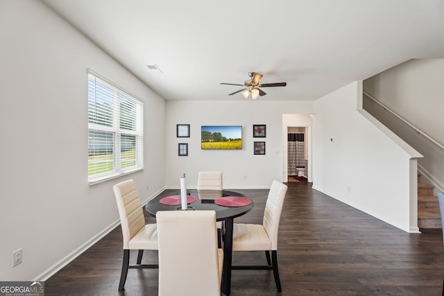 dining room with dark wood-type flooring and ceiling fan