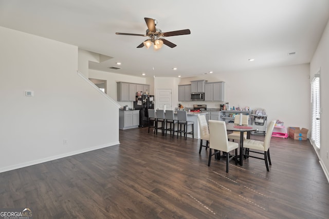 dining area with dark hardwood / wood-style flooring and ceiling fan