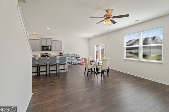 dining area featuring ceiling fan and dark hardwood / wood-style flooring