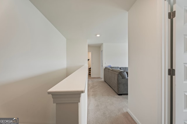 hallway featuring light colored carpet